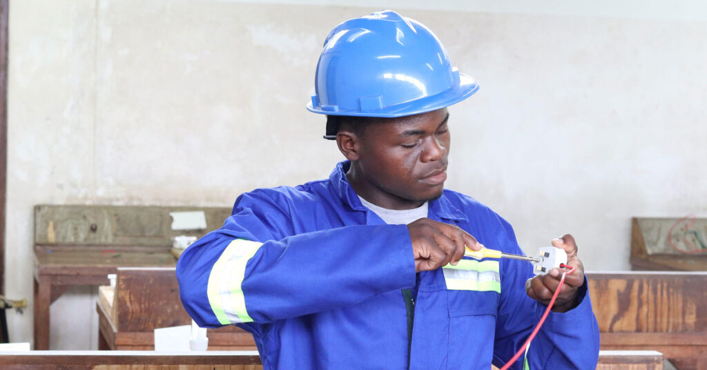 Man working on a small device with a screwdriver